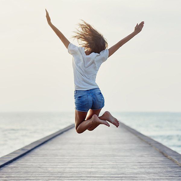 woman jumping in the air with excitement